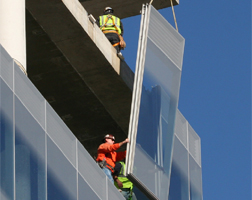 Installing a glass curtain wall.